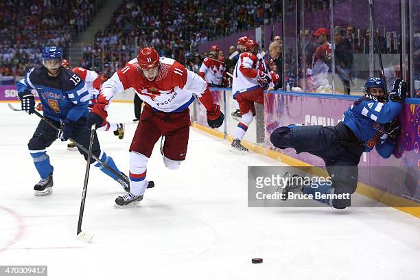 Yevgeni Malkin of Russia knocks Sami Vatanen of Finland into the boards during the Men's Ice Hockey Quarterfinal Playoff on Day 12 of the 2014 Sochi...