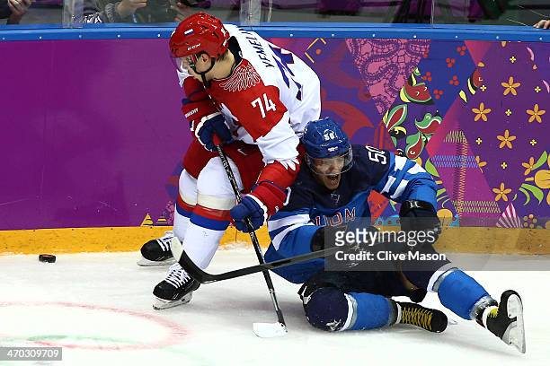 Juhamatti Aaltonen of Finland falls to the ice against Alexei Yemelin of Russia during the Men's Ice Hockey Quarterfinal Playoff on Day 12 of the...