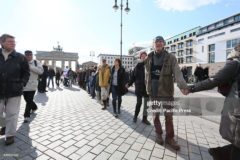 Activists create a protest chain between Potsdamer Platz...