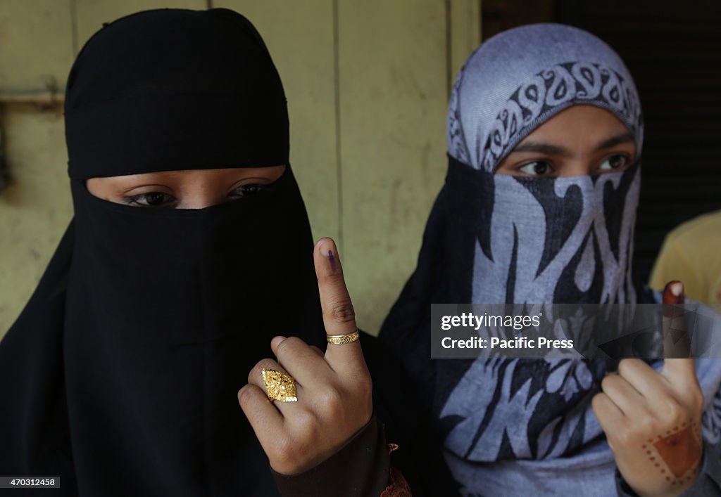 Indian Muslim girl show the mark finger after cast the vote...