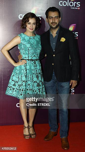 Indian Bollywood actress Dia Mirza poses for a photograph alongside her husband during a promotional event in Mumbai on late April 18, 2015. AFP...