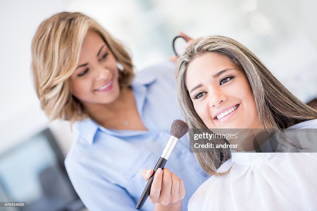 Woman getting her makeup done at the salon