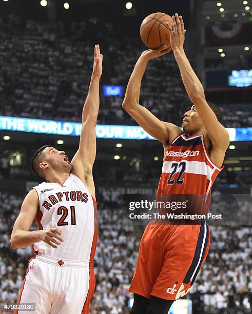 Washington Wizards forward Otto Porter Jr. Fires a shot over Toronto Raptors guard Greivis Vasquez during game one action on April 18, 2015 in...