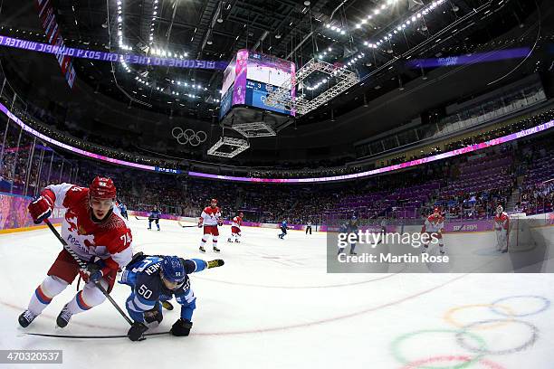 Juhamatti Aaltonen of Finland falls to the ice after colliding with Alexei Yemelin of Russia during the Men's Ice Hockey Quarterfinal Playoff on Day...