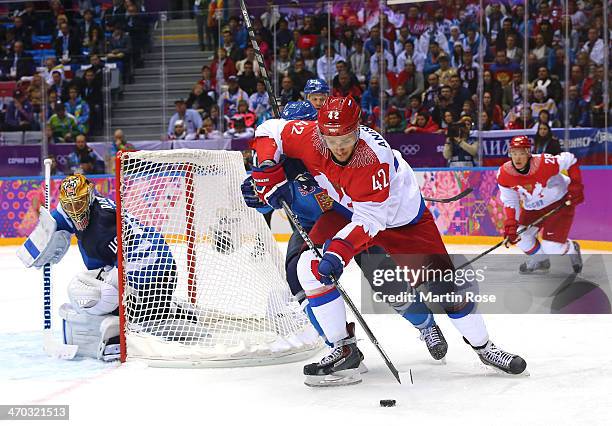 Artyom Anisimov of Russia skates around the net of Tuukka Rask of Finland with the puck during the Men's Ice Hockey Quarterfinal Playoff on Day 12 of...