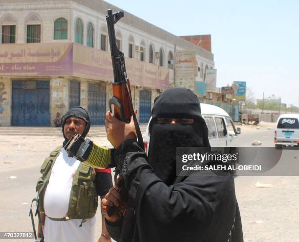 Umm Raed, a female fighter with Yemen's separatist Southern Movement who says she is eight months pregnant, holds an automatic rifle while manning a...