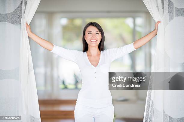 woman relaxing at home - window curtains stock pictures, royalty-free photos & images