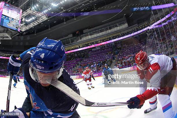 Yevgeni Malkin of Russia hits Ossi Vaananen of Finland with his stick during the Men's Ice Hockey Quarterfinal Playoff on Day 12 of the 2014 Sochi...