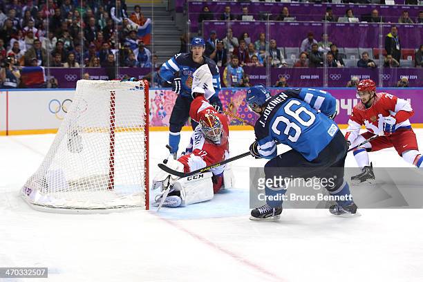 Sergei Bobrovski of Russia makes a save against Jussi Jokinen of Finland during the Men's Ice Hockey Quarterfinal Playoff on Day 12 of the 2014 Sochi...