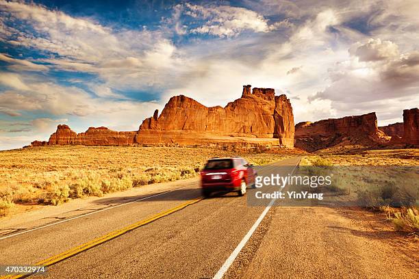 car driving road trip touring at arches national park utah - utah scenics stock pictures, royalty-free photos & images