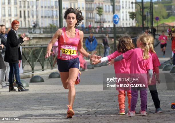 Participant takes part in the 7th edition of the 10km Odyssea race on April 19, 2015 in Bayonne, southwestern France, aimed at raising funds for the...