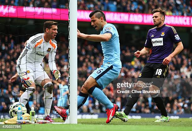 Sergio Aguero of Manchester City celebrates as James collins of West Ham scores an own goal during the Barclays Premier League match between...