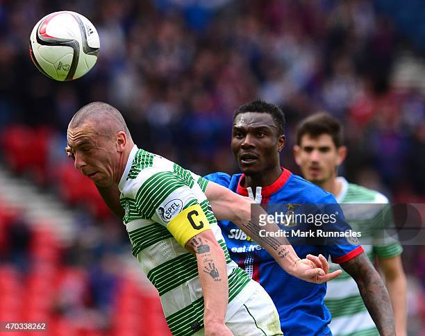 Scott Brown of Celtic clears from Edward Ofere of Inverness Caledonian Thistle during the William Hill Scottish Cup Semi Final match between...