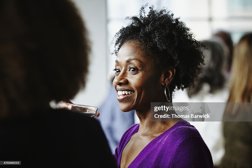Woman having drinks with friends at party