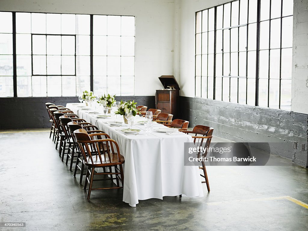 Banquet table set for dinner in loft