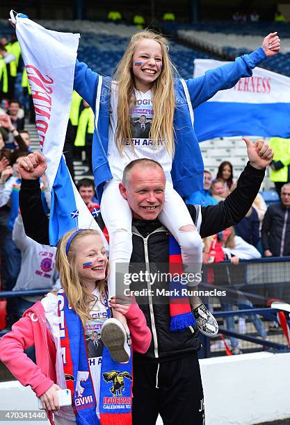 Inverness Caledonian Thistle manager John Hughes celebrates his teams victory over Celtic with his twin daughters Jessica and Victoria on during the...