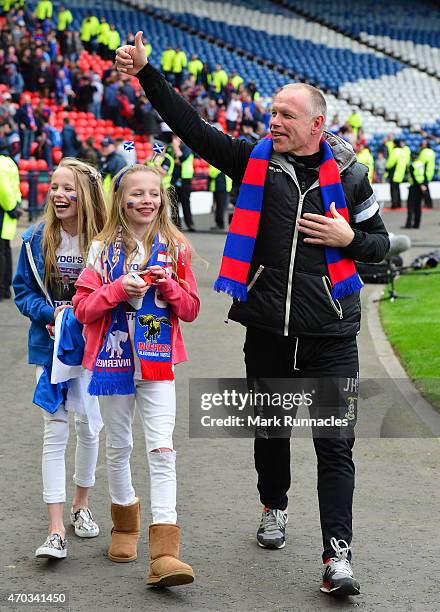 Inverness Caledonian Thistle manager John Hughes celebrates his teams victory over Celtic with his twin daughters Jessica and Victoria on during the...