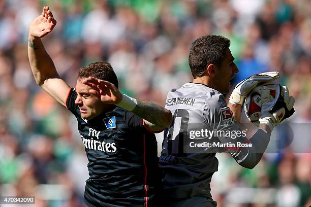 Koen Casteels, keeper of Bremen safes the ball against Pierre-Michel Lasogga of Hamburg during the Bundesliga match between SV Werder Bremen and...