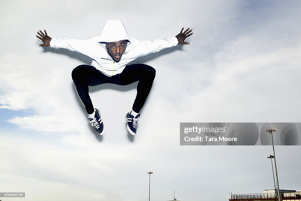 Sports man jumping into the sky