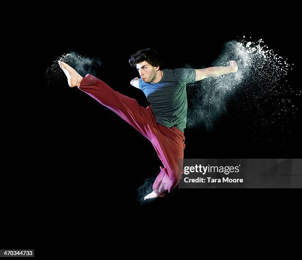 urban man kicking in air with powder - karate high kick stock pictures, royalty-free photos & images