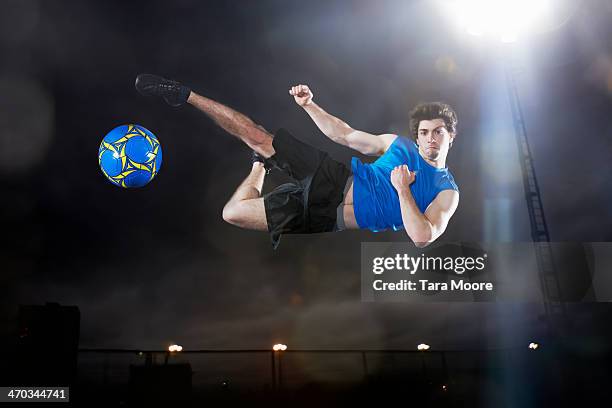 football kicking ball in midair - up in the air stock pictures, royalty-free photos & images
