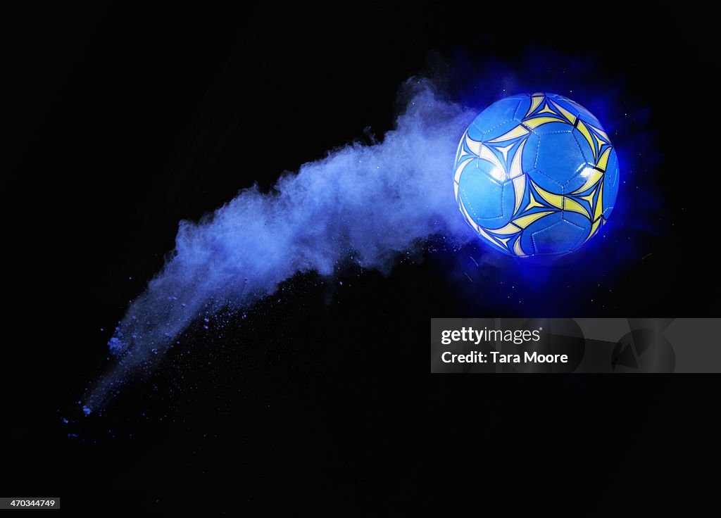 Ball in mid air with blue smoke and powder