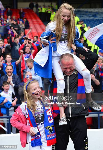 Inverness Caledonian Thistle manager John Hughes celebrates his teams famous victory over Celtic with his twin daughters Jessica and Victoria on...
