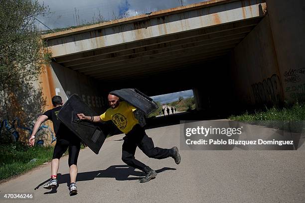 Race volunteer tries to stop competitors using shields during the first Belik Race on April 19, 2015 in Cabanillas del Campo, in the region of...