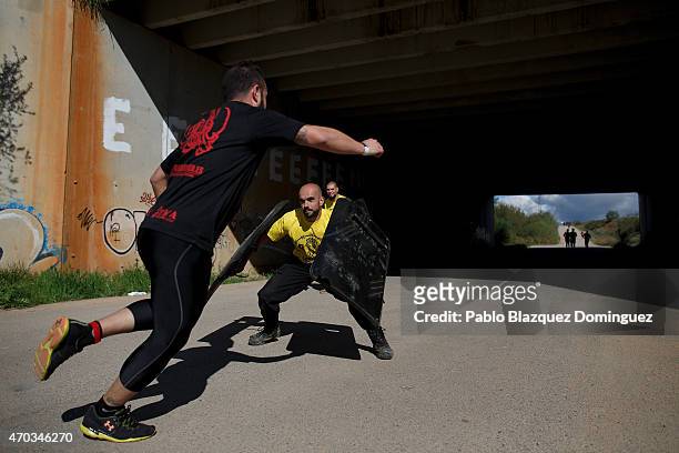 Race volunteer tries to stop competitors using shields during the first Belik Race on April 19, 2015 in Cabanillas del Campo, in the region of...