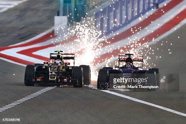 Pastor Maldonado of Venezuela and Lotus and Max Verstappen of Netherlands and Scuderia Toro Rosso drive during the Bahrain Formula One Grand Prix at...