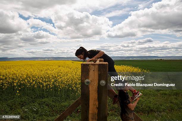 Competitor helps another one to climb over a wooden wall during the first Belik Race on April 19, 2015 in Cabanillas del Campo, in the region of...