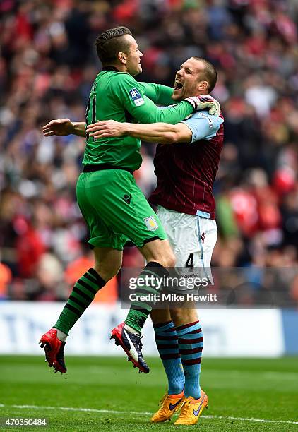 Shay Given and Ron Vlaar of Aston Villa celebrate victory after the FA Cup Semi Final between Aston Villa and Liverpool at Wembley Stadium on April...