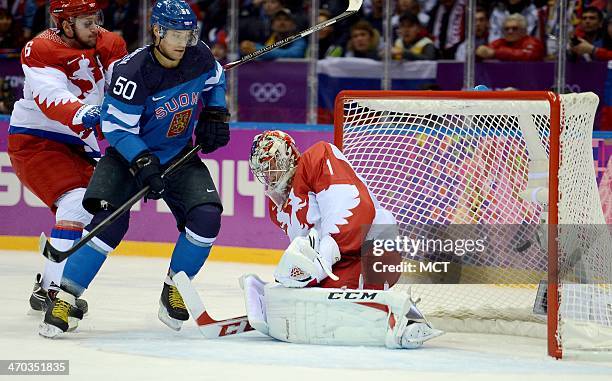 Finland forward Juhamatti Aaltonen scores past Russia goalie Semyon Varlamov in the first period of a Winter Olympics quarterfinal at the Bolshoy Ice...