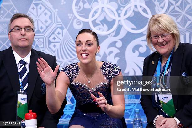 Jenna McCorkell of Great Britain waits for her score with her coaches Simon Briggs and Debi Briggs in the Figure Skating Ladies' Short Program on day...