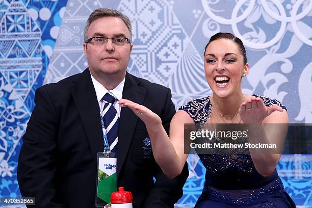 Jenna McCorkell of Great Britain waits for her score with her coach Simon Briggs in the Figure Skating Ladies' Short Program on day 12 of the Sochi...