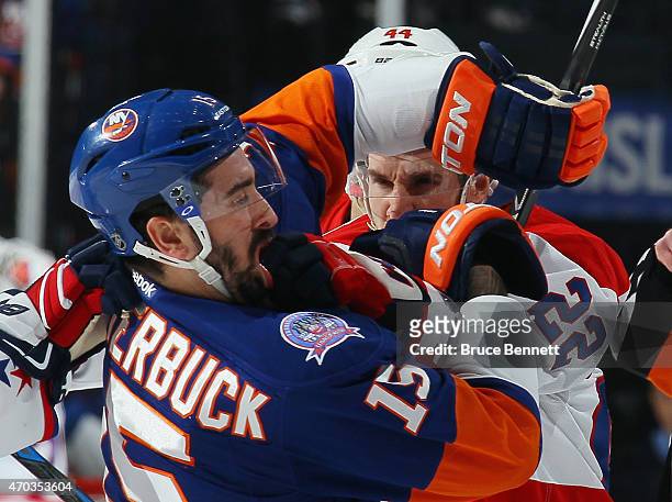 Cal Clutterbuck of the New York Islanders and Curtis Glencross of the Washington Capitals exchange blows during the first period in Game Three of the...