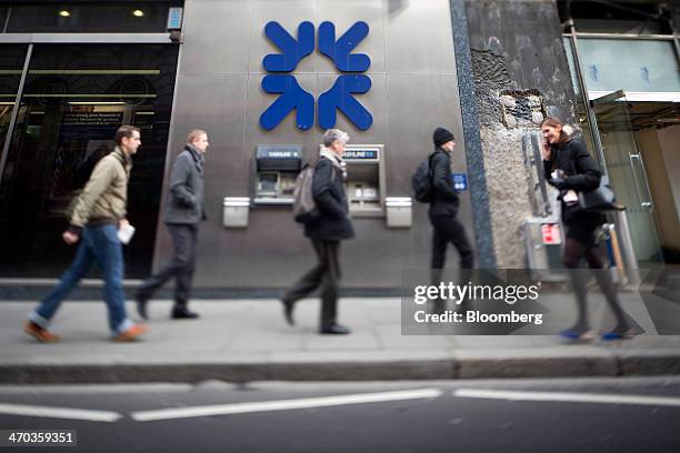 Pedestrians walk past a Royal Bank of Scotland Group Plc bank branch in this image taken with a tilt-shift lens in London, U.K., on Wednesday, Feb....