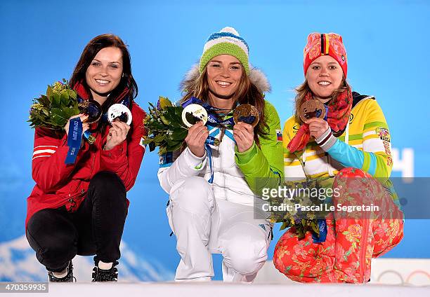 Silver medalist Anna Fenninger of Austria, gold medalist Tina Maze of Slovenia and bronze medalist Viktoria Rebensburg of Germany celebrate on the...