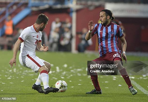 Sabri Sarioglu of Galatasaray in action against Erkan Zengin of Trabzonspor during the Turkish Spor Toto Super League soccer match between...