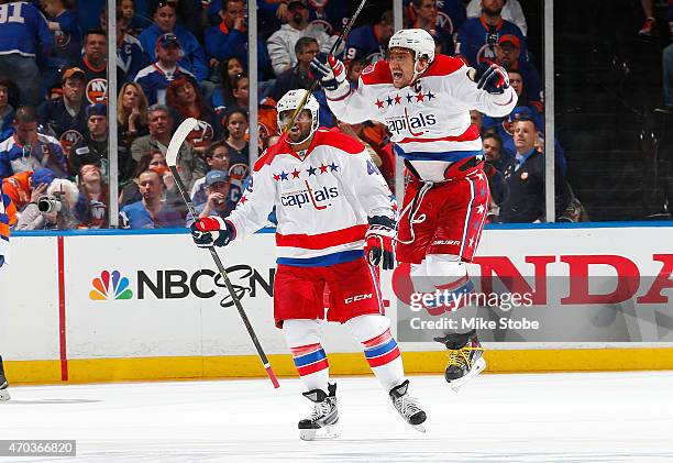 Alex Ovechkin and Joel Ward of the Washington Capitals celebrate a goal by teammate Nicklas Backstrom during the game against the New York Islanders...