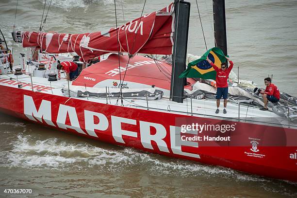 In this handout image provided by the Volvo Ocean Race, Brazilian MAPFRE crew member, Andre Fonseca, aka Bochecha, waves to the crowds with the...