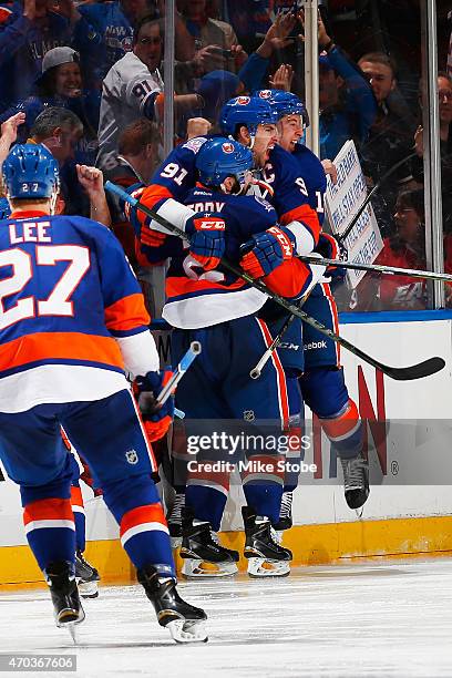 John Tavares of the New York Islanders is congratulated on his game winning goal in overtime by teammates Nick Leddy and Ryan Strome during the game...