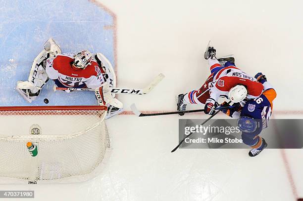 John Tavares of the New York Islanders fires the puck past Braden Holtby of the Washington Capitals for the game winning overtime goal during Game...