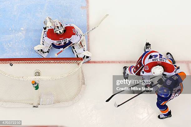 John Tavares of the New York Islanders fires the puck past Braden Holtby of the Washington Capitals for the game winning overtime goal during Game...