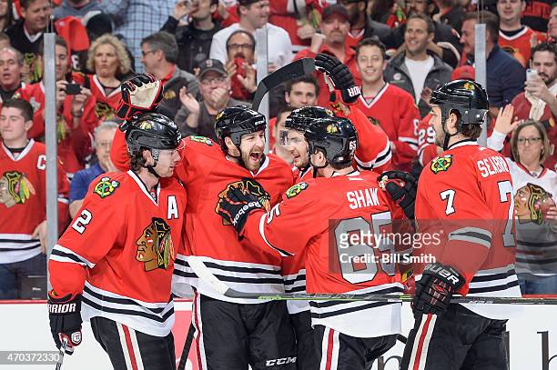 Duncan Keith, Andrew Desjardins, Marcus Kruger, Andrew Shaw and Brent Seabrook of the Chicago Blackhawks celebrate after Desjardins scored against...