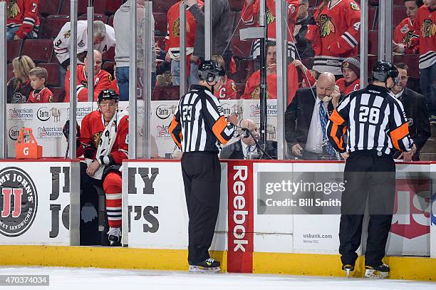 Marian Hossa of the Chicago Blackhawks sits in the penalty box as the officials decide if any time was left on the clock for the first period, during...