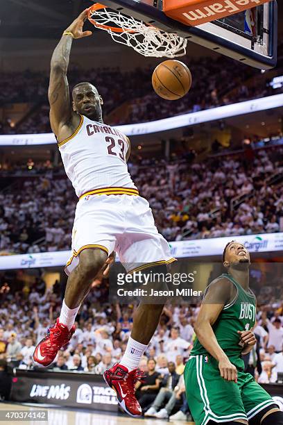 LeBron James of the Cleveland Cavaliers dunks over Evan Turner of the Boston Celtics in the first half during Game One in the Eastern Conference...