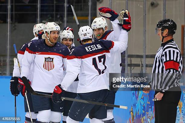 James van Riemsdyk of the United States celebrates with his teammates after scoring a goal in the first period against Ondrej Pavelec of the Czech...