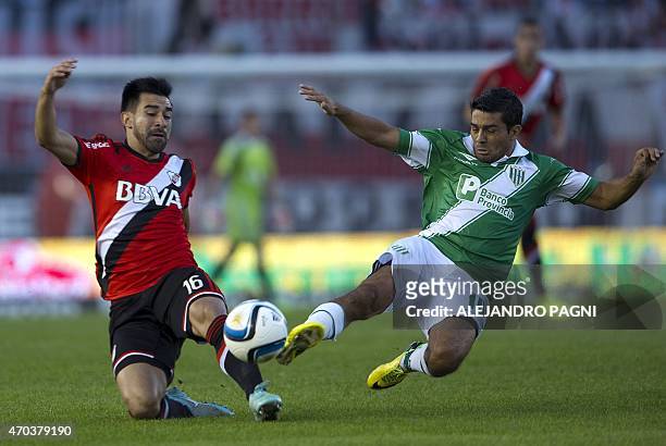 Banfield's midfielder Walter Erviti vies for the ball with River Plate's midfielder Ariel Rojas during their Argentina First Division football match...