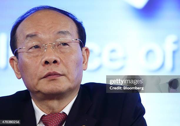 Xu Ping, chairman of Dongfeng Motor Group Co., attends a joint news conference with Carlos Tavares, chief executive officer of PSA Peugeot Citroen,...